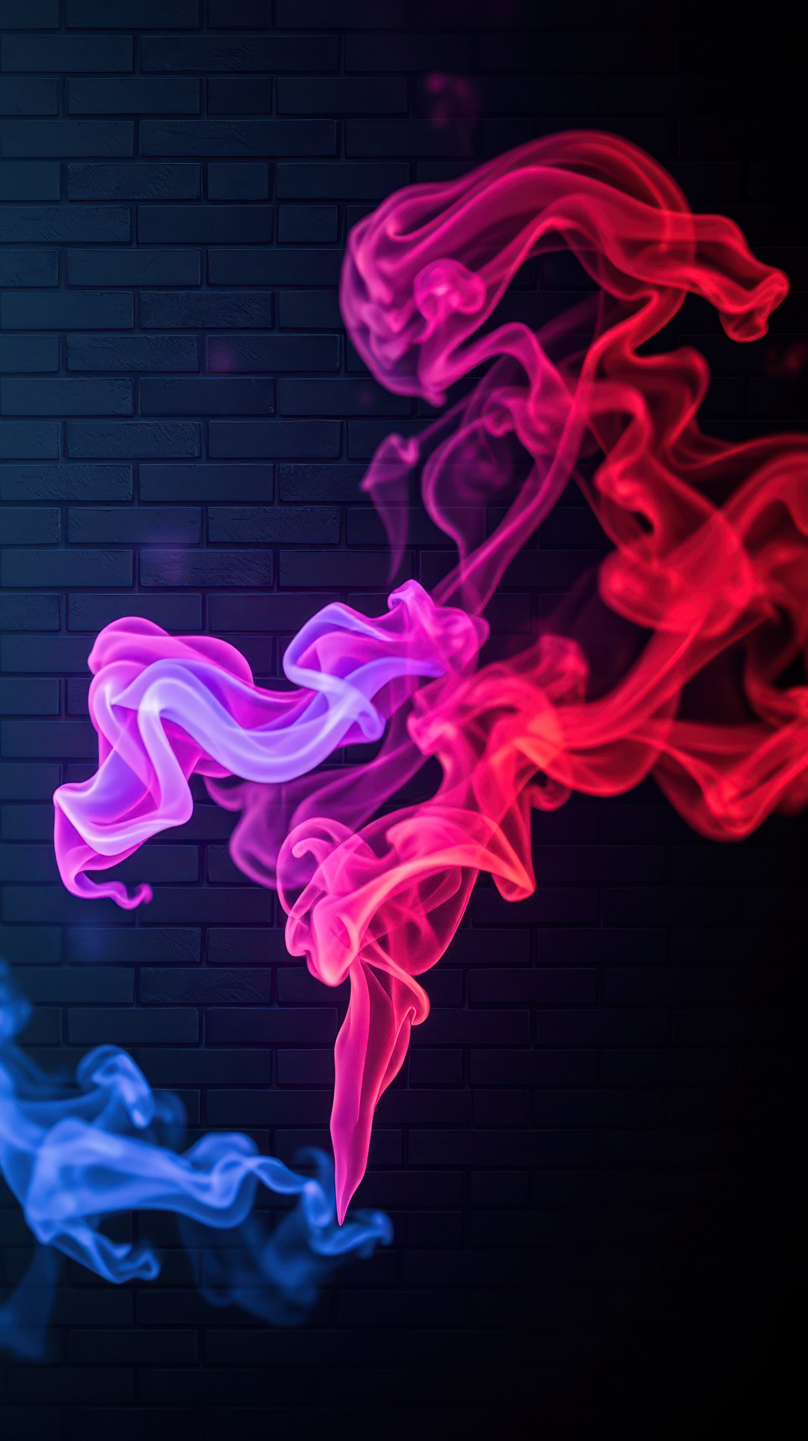 Colorful smoke patterns swirl against a dark brick background creating a captivating visual display during nighttime